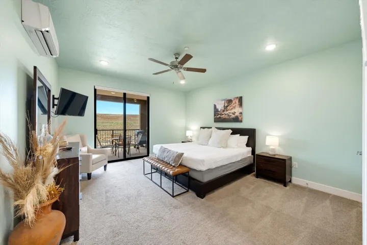 Spacious interior featuring a sliding glass door to a private balcony, ceiling fan, recessed lighting, and individual climate control unit