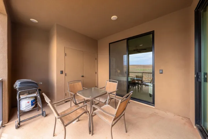 Covered outdoor patio with a textured concrete surface and recessed lighting