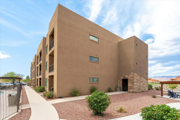 Multi-story stucco building with stone accents
