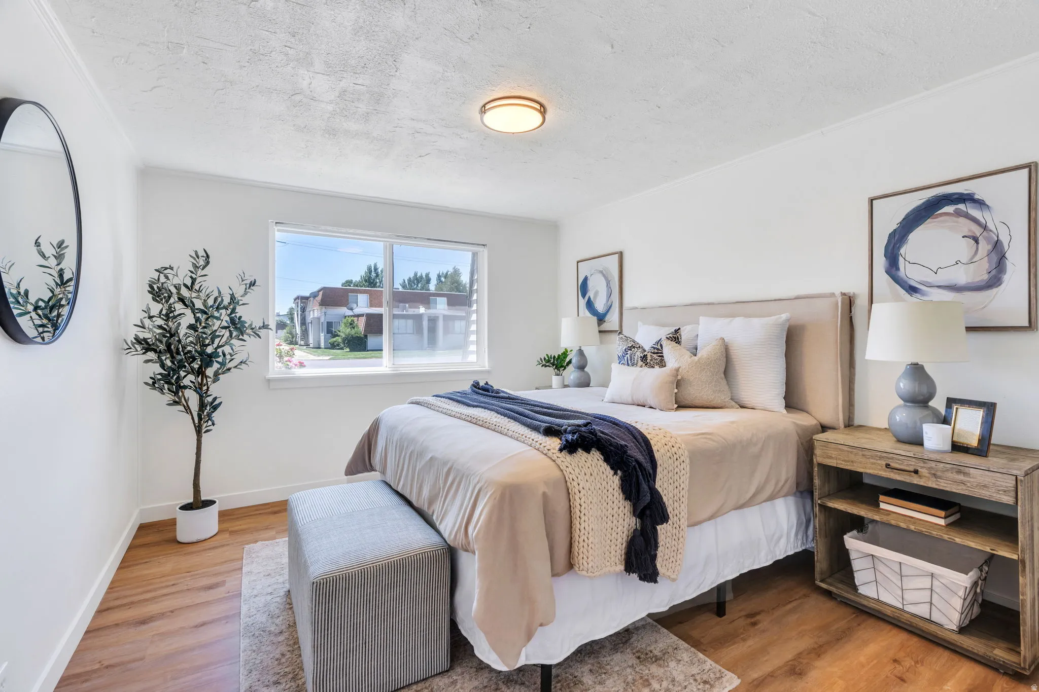 Bedroom featuring wood-finish flooring, a contemporary overhead light fixture, and a large window