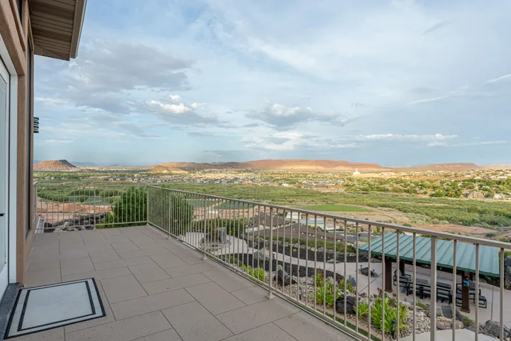 Expansive outdoor patio featuring large format tile flooring and metal railings