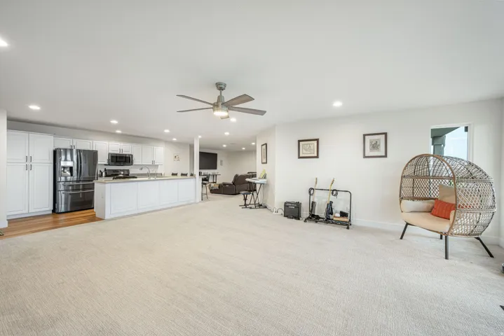 Expansive open-concept living space with recessed lighting and a ceiling fan