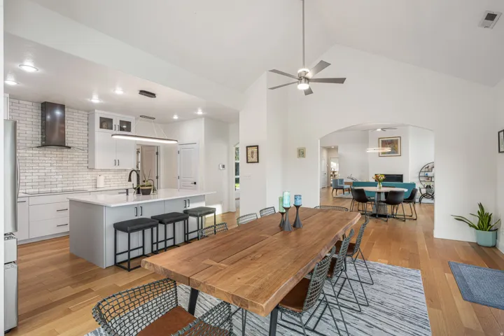 Open-concept kitchen and dining area featuring wood-finish flooring
