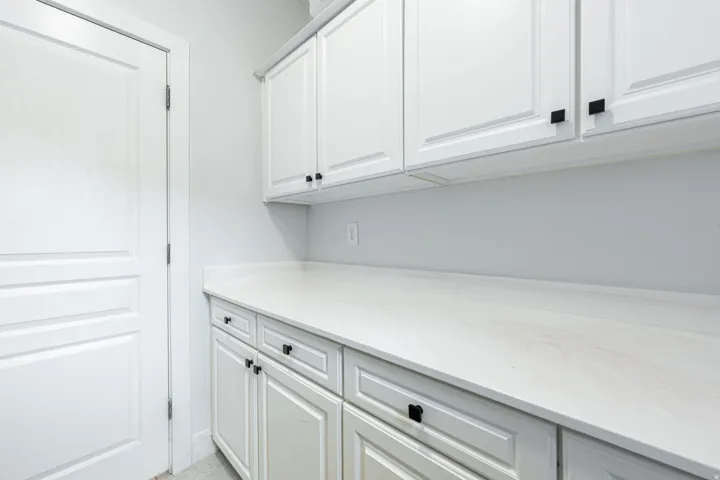 Built-in cabinetry with white shaker-style doors and black hardware