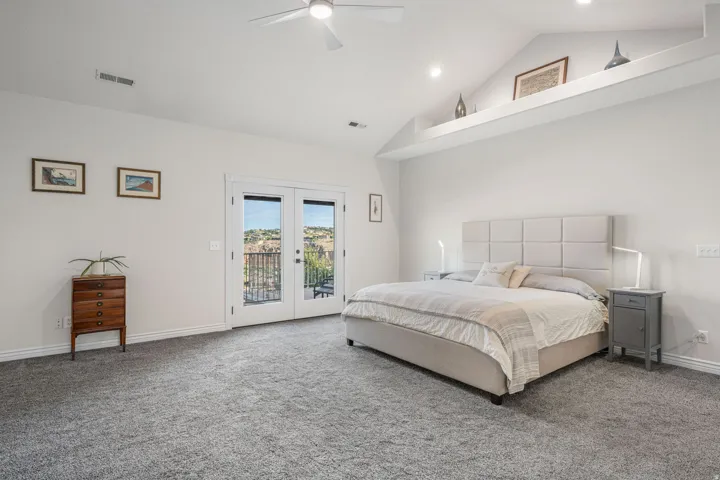 Spacious room featuring vaulted ceilings, a ceiling fan, recessed lighting, and grey carpeting
