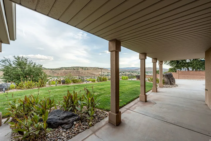 Covered patio featuring robust square columns and a concrete surface