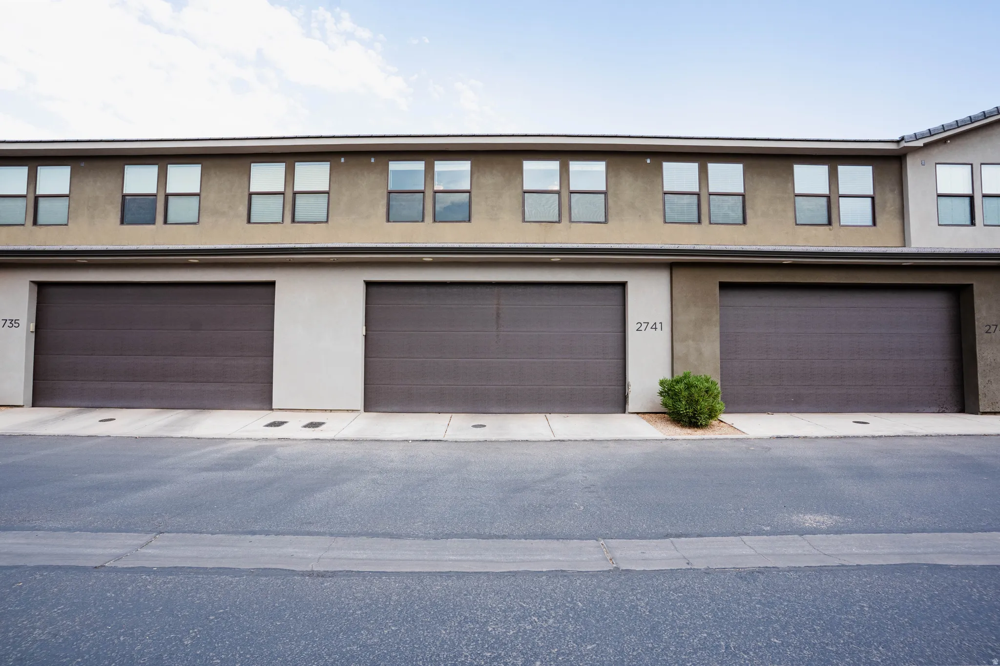 Multi-unit property with three individual garage doors