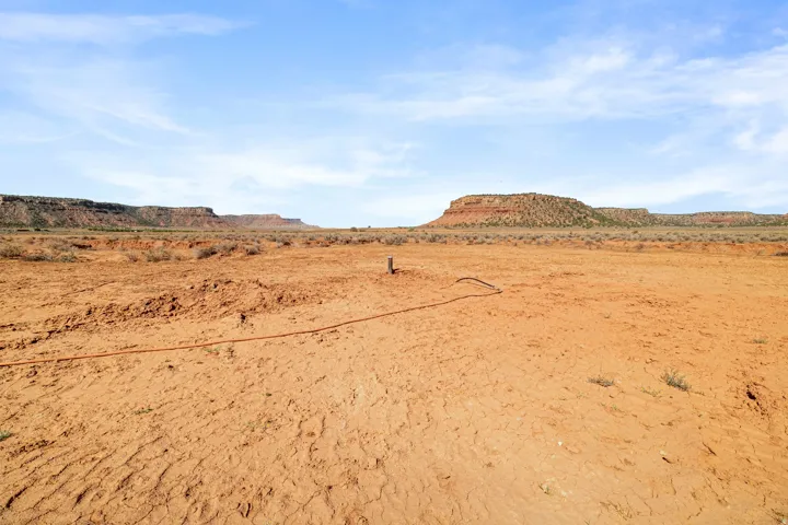 Expansive desert landscape featuring red rock formations