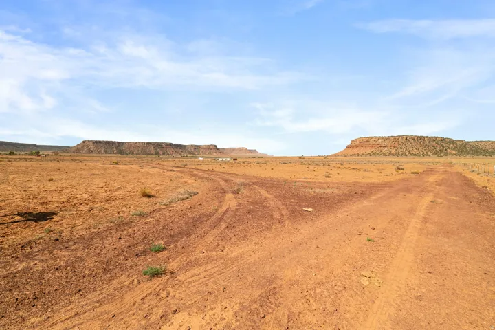 Expansive desert landscape featuring rugged terrain and distant mesas