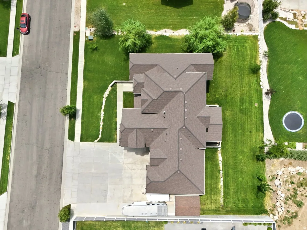 Expansive property with a large, multi-gabled roofline and an extensive concrete driveway