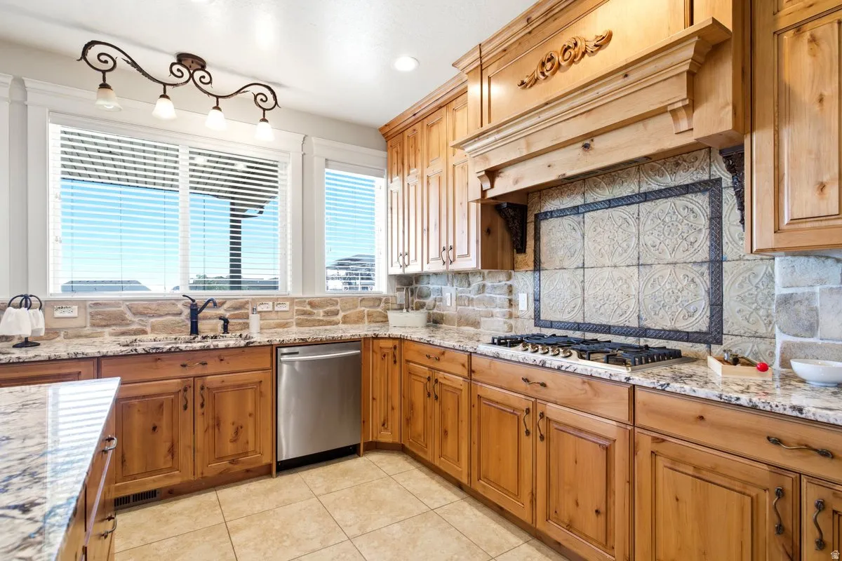 Kitchen with wood-finish cabinetry, granite countertops, and a stone tile backsplash