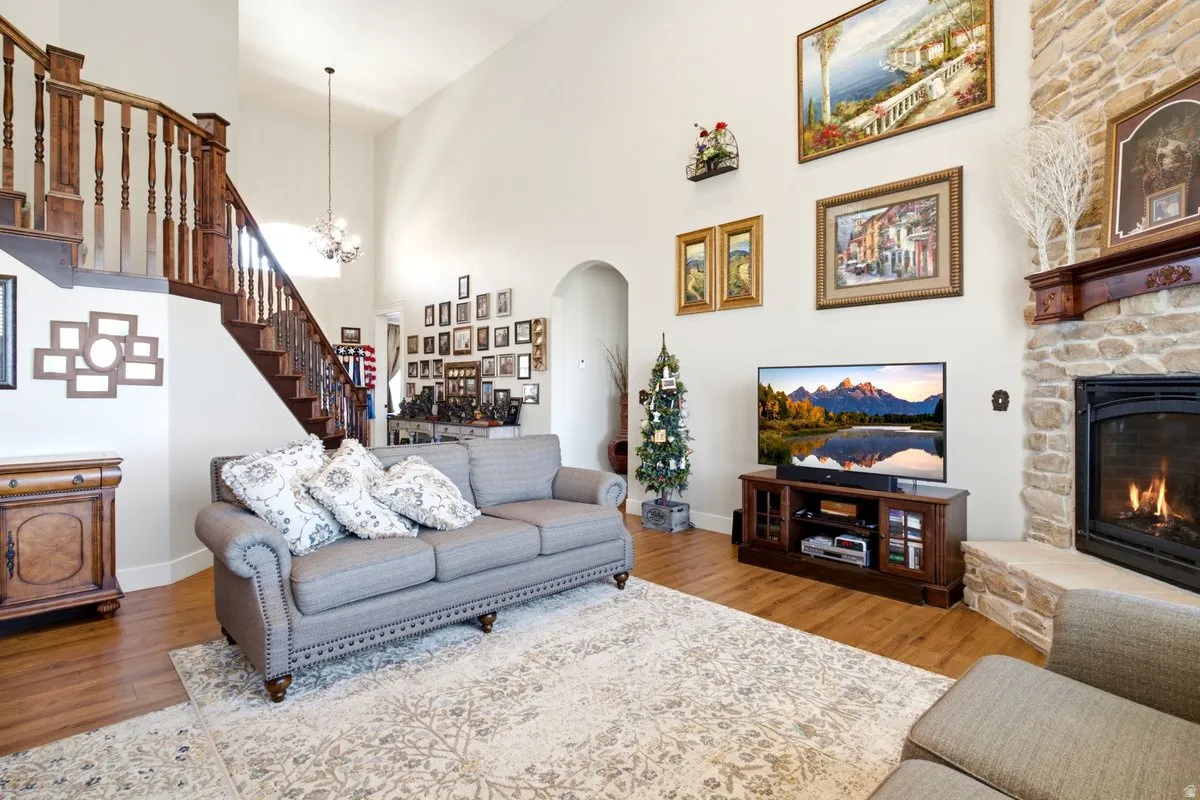 Spacious living area featuring a vaulted ceiling and wood-finish flooring