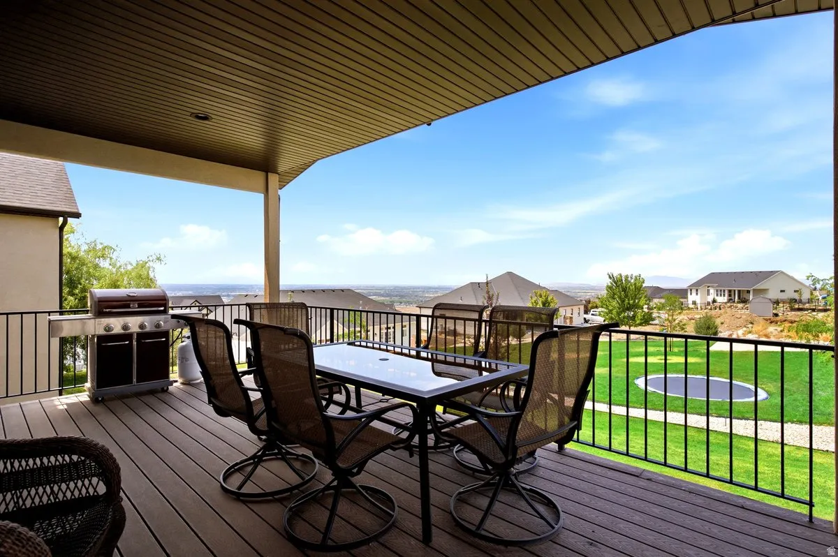 Covered deck featuring composite decking and black metal railings