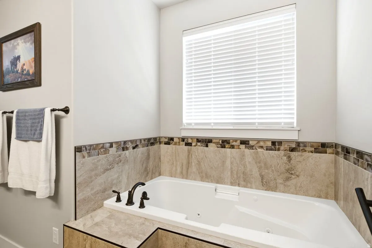 White built-in soaking tub with dark bronze fixtures