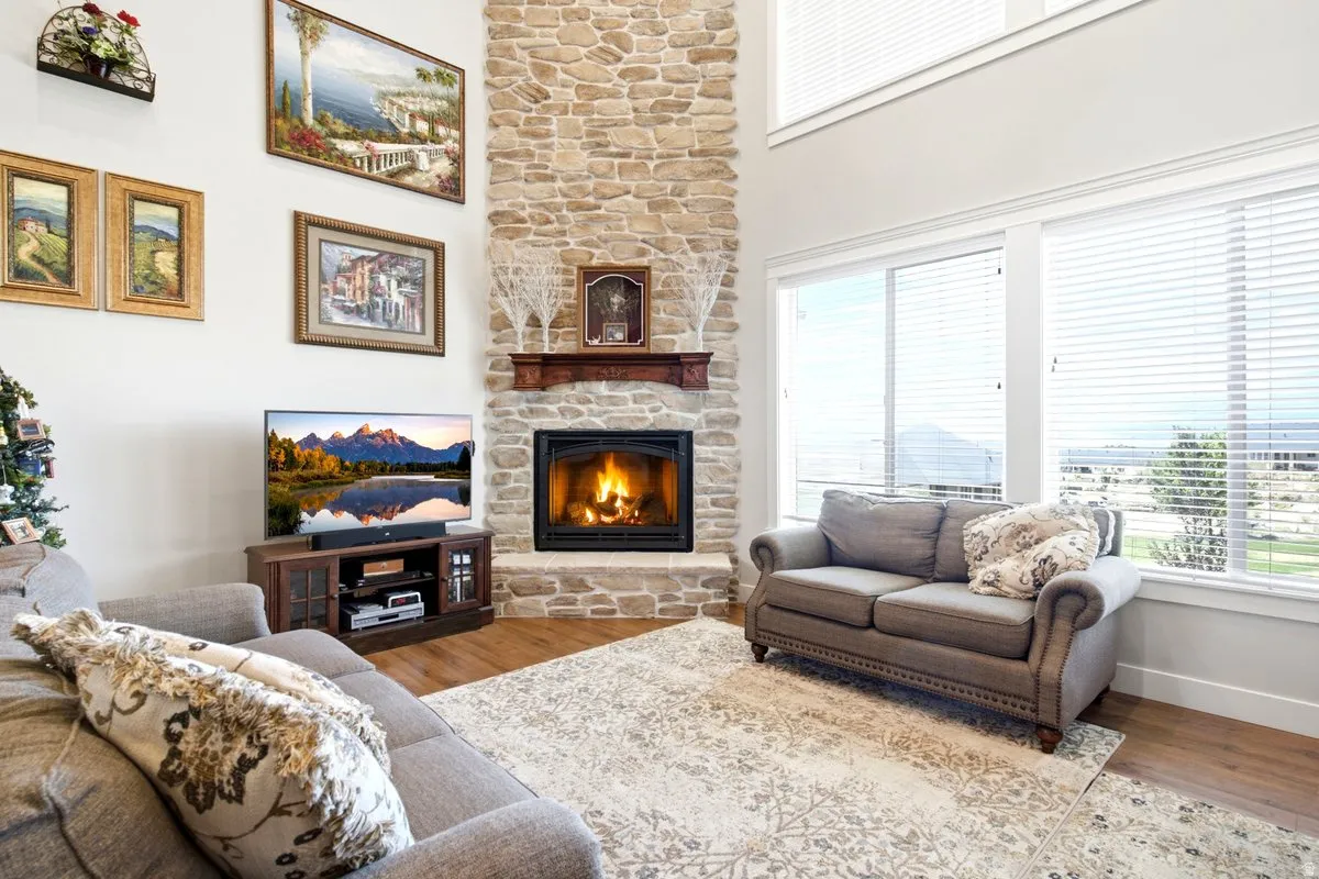 Corner fireplace with a stone surround and wood mantel