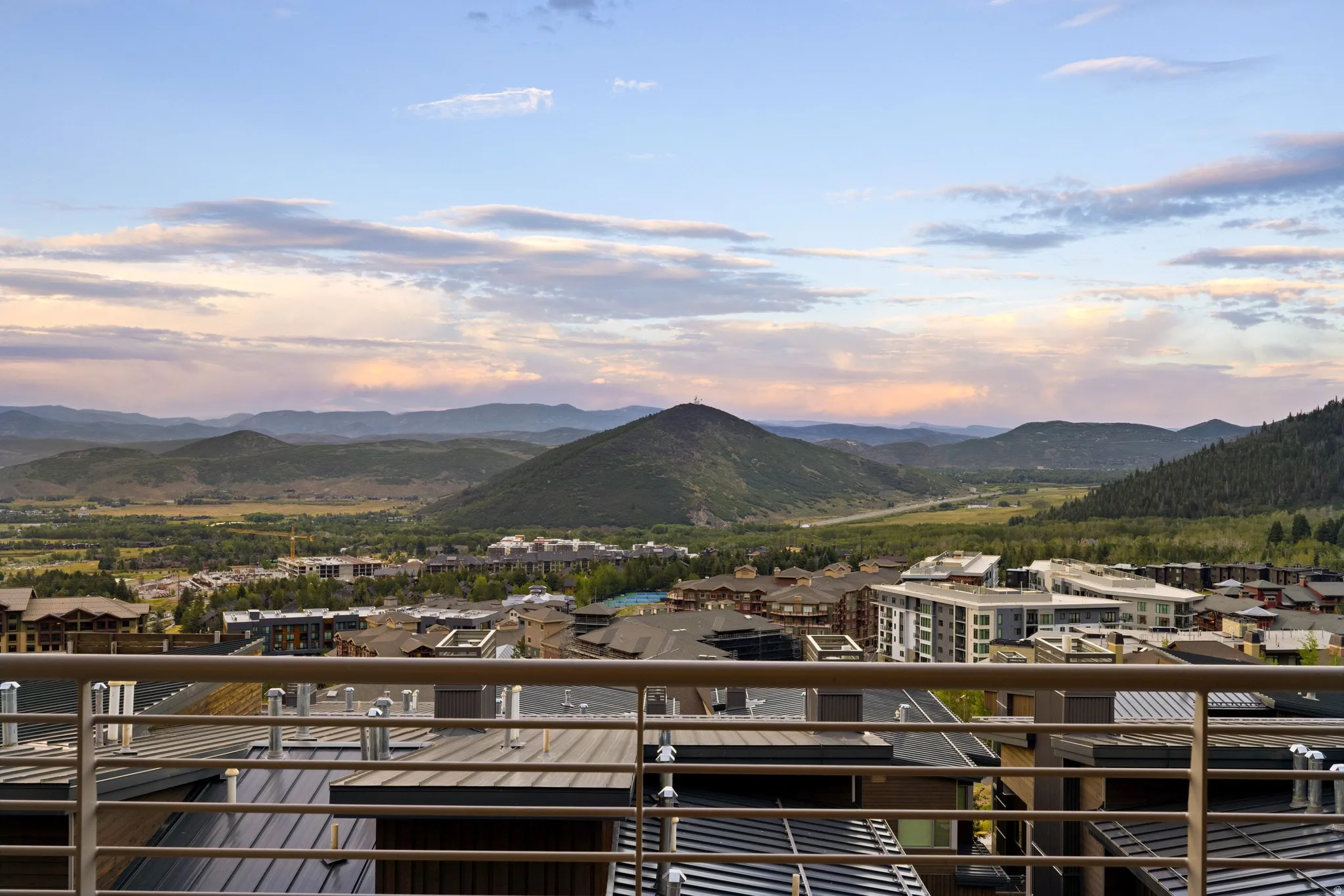 Expansive mountain scenery framing a valley and distant community
