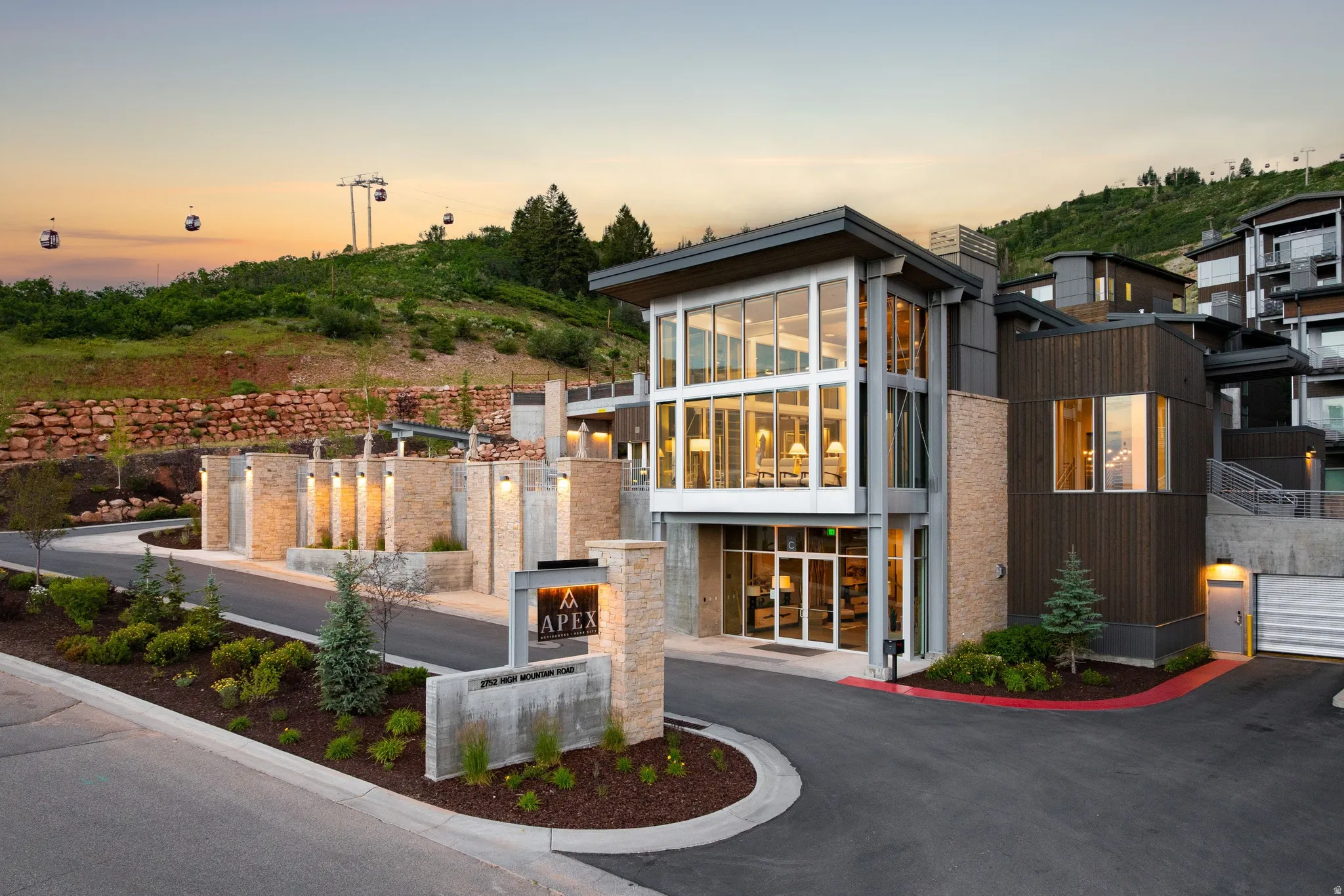 Modern architectural design featuring large expanses of glass, wood-panel siding, and stone accents
