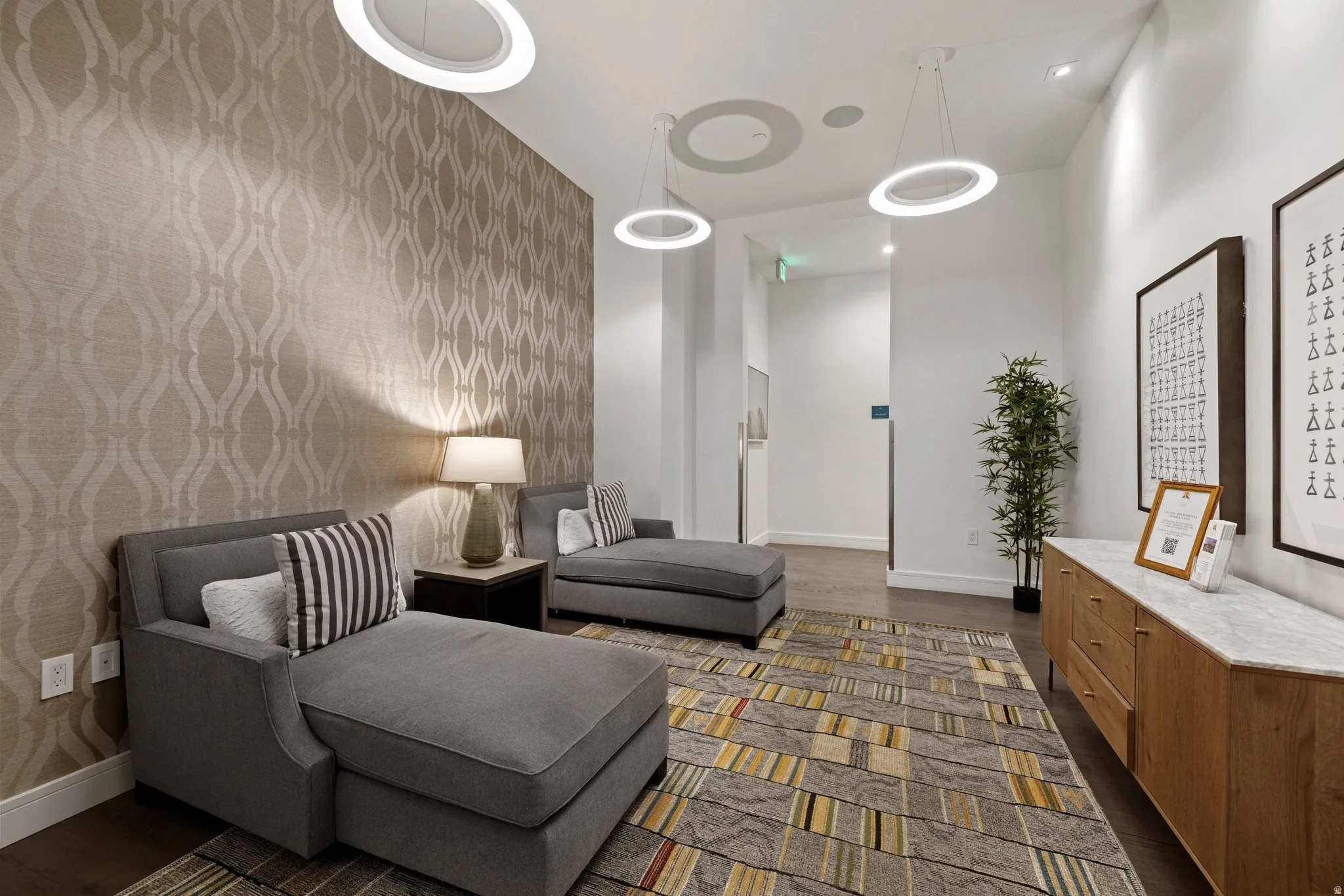 Interior space featuring a patterned accent wall, recessed lighting, and modern pendant fixtures