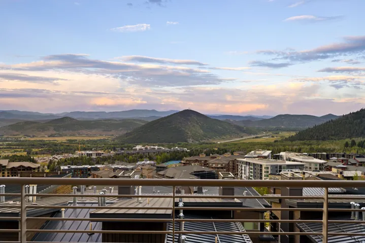 Expansive mountain scenery framing a valley and distant community