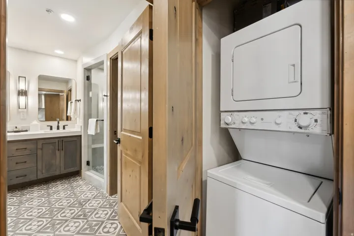 Bathroom featuring a dark wood-finish vanity with a white countertop and a walk-in shower with a glass enclosure
