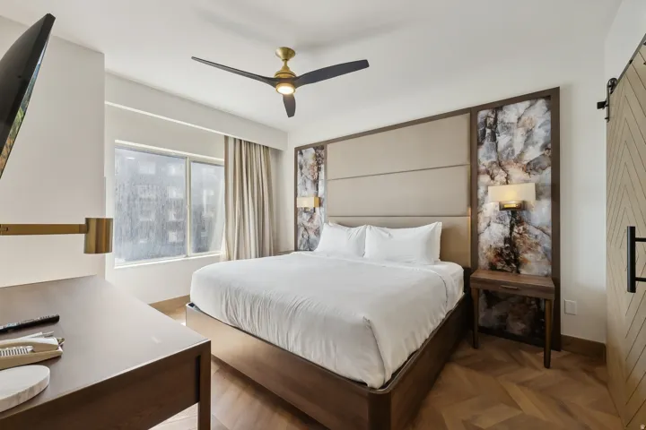 Herringbone wood-finish flooring provides a refined foundation for this space