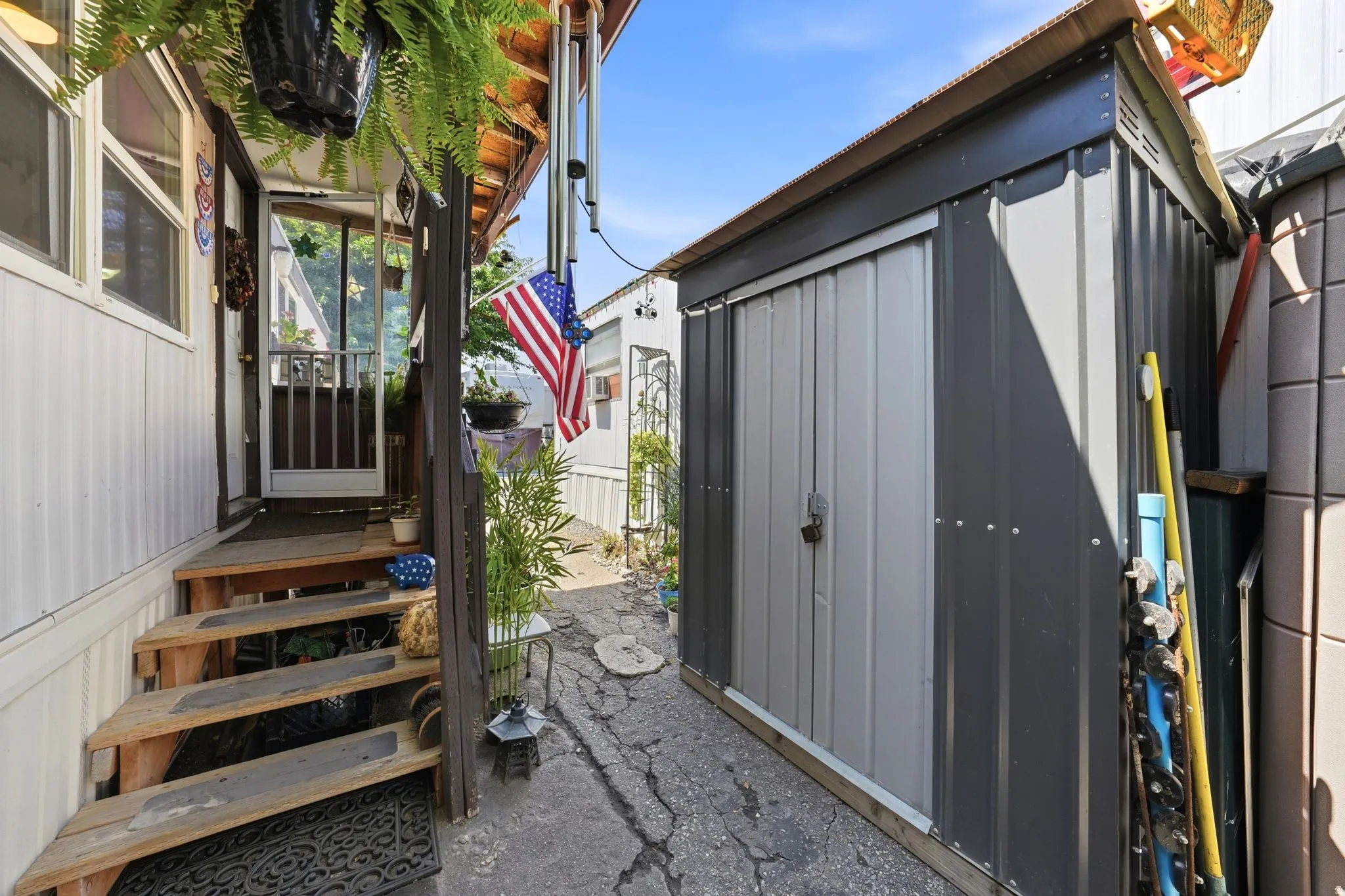 Exterior entry with wood steps and a partially screened door