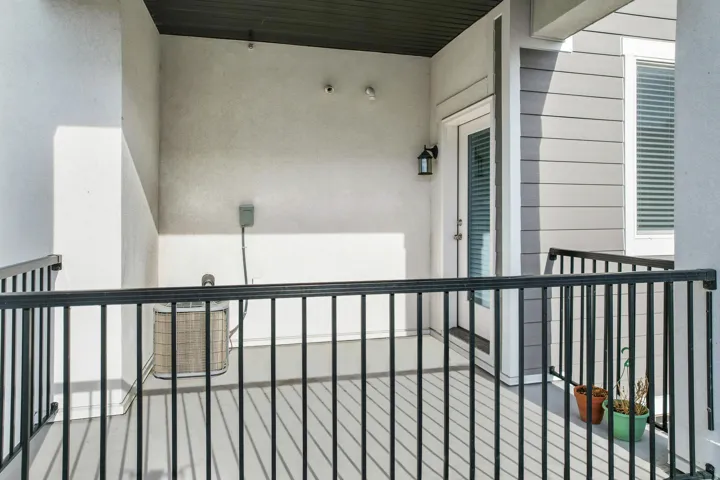 Private balcony featuring black metal railings and a gray finished floor