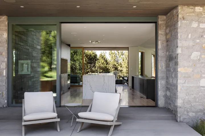 Expansive outdoor patio with concrete flooring and stone exterior walls