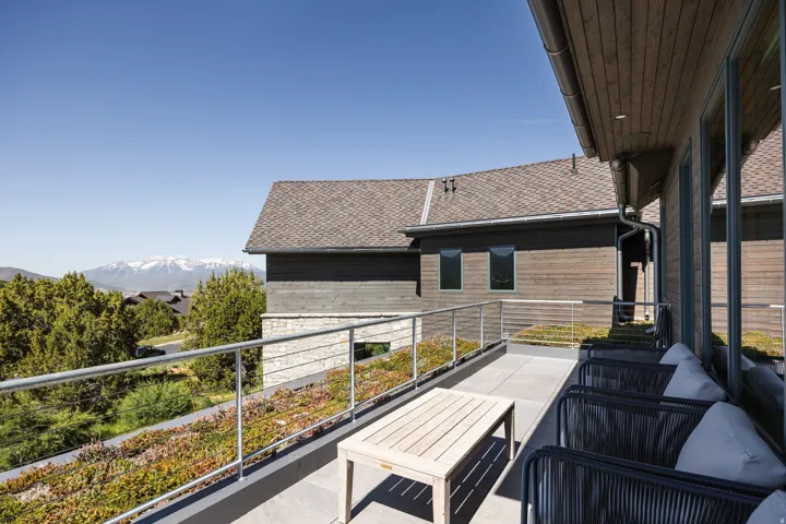 Spacious outdoor terrace with tile flooring and a cable railing system