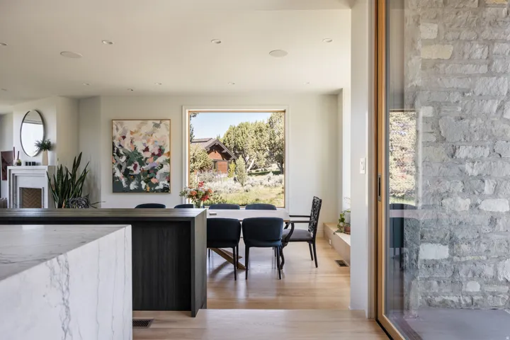 Open-concept dining area with natural wood-finish flooring