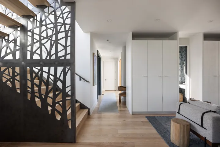 Custom metal stair railing with a tree-motif design
