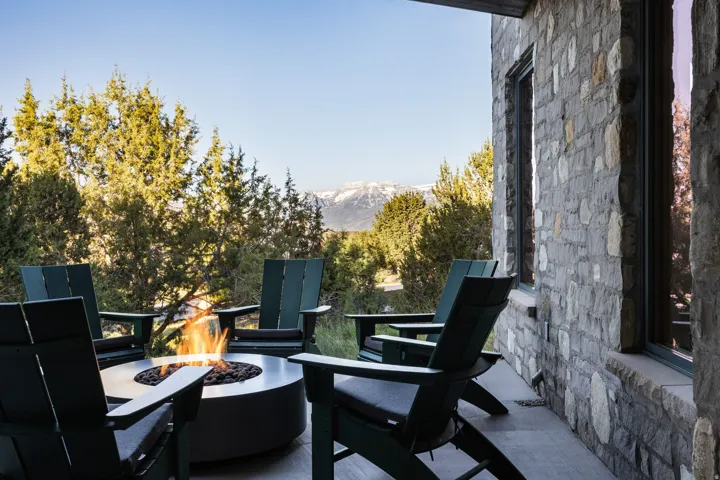 Stone exterior patio featuring a built-in fire pit, stone flooring, and expansive mountain scenery