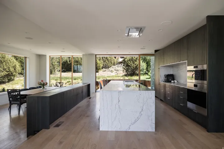 Open-concept kitchen and dining area featuring light wood-finish flooring