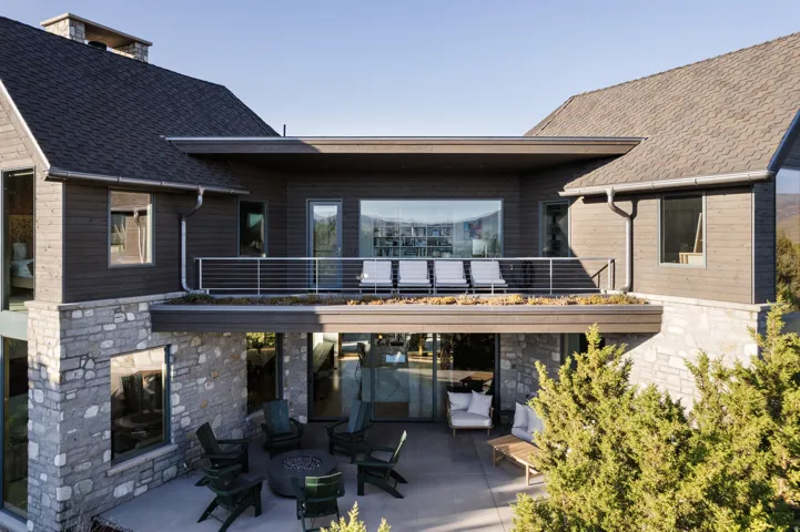 Multi-level exterior featuring stone and wood-panel siding