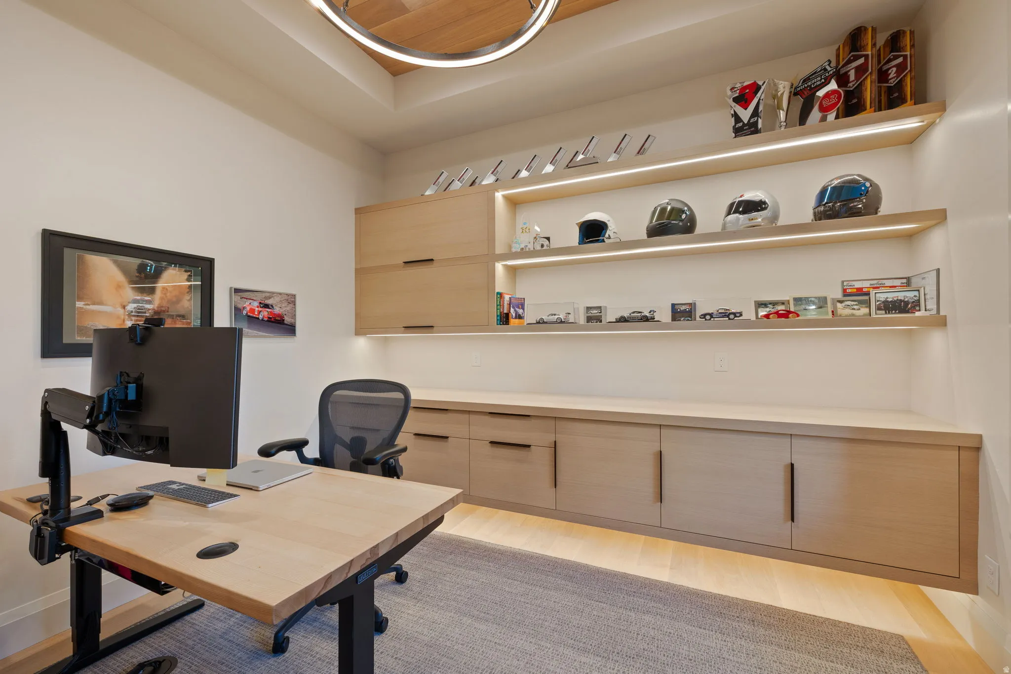 Dedicated office space featuring built-in light wood cabinetry and shelving