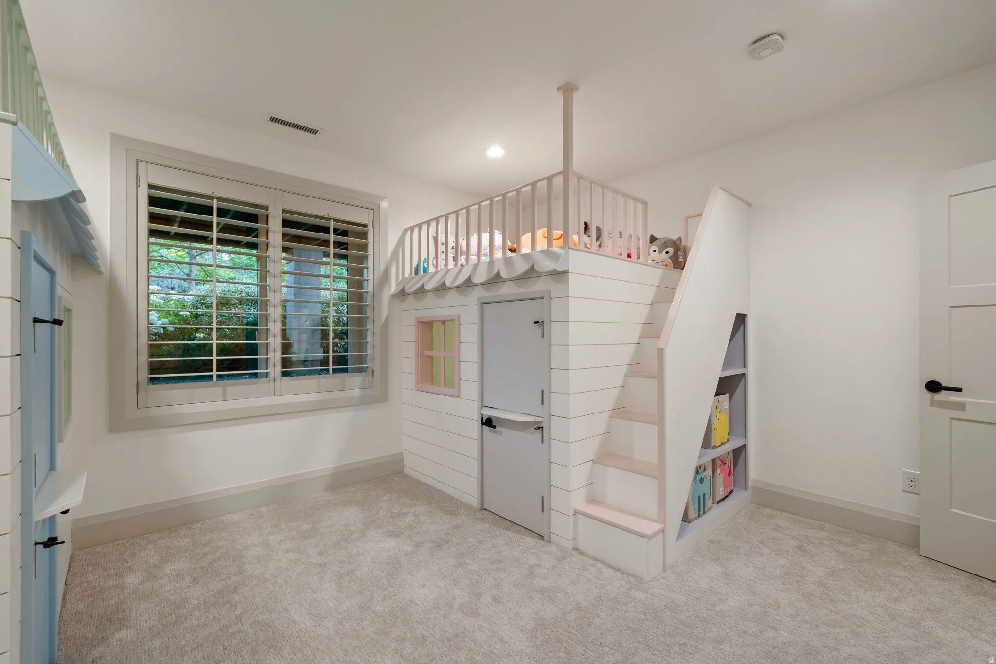 Custom built-in loft bed with integrated shelving and shiplap-style siding