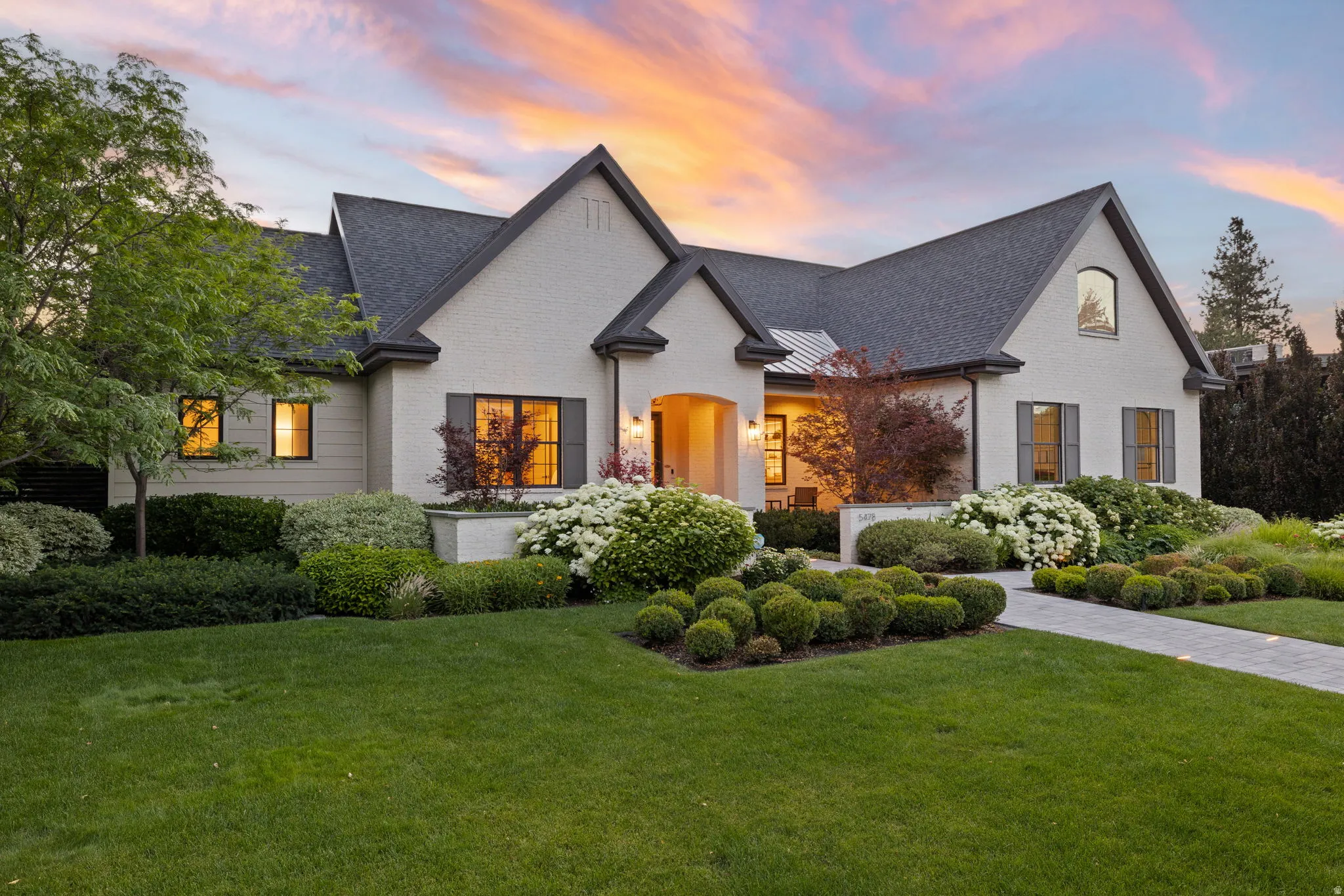 Brick and siding exterior with dark grey gables and a coordinated shingle roof
