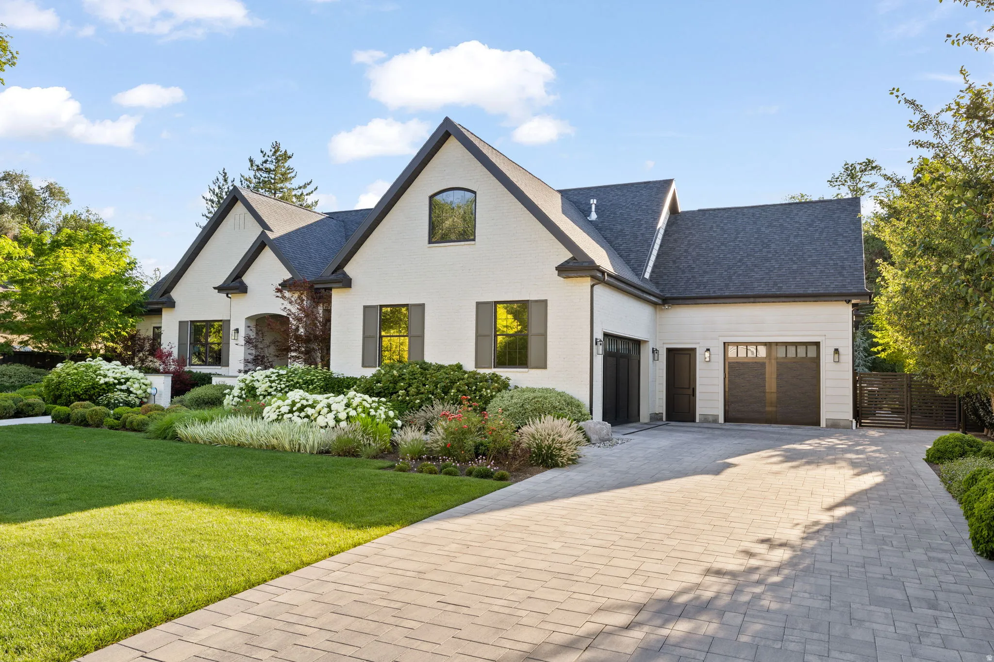 White brick exterior with dark trim and shutters