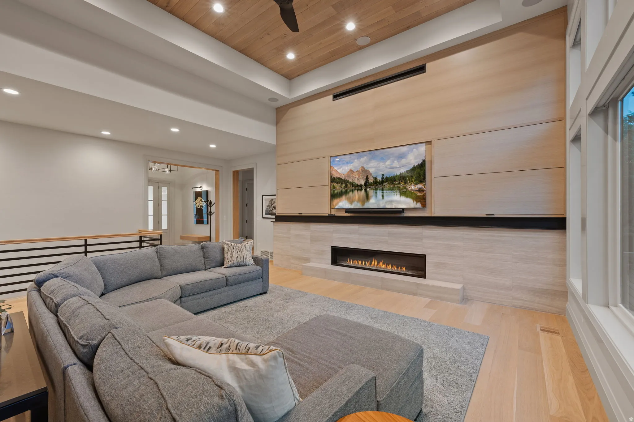 Living area featuring a modern linear fireplace with a stone surround