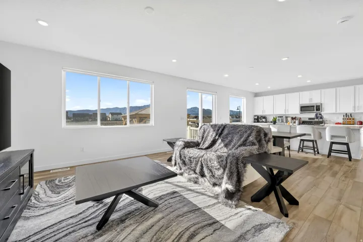 Open concept living area featuring wood-finish flooring and recessed lighting