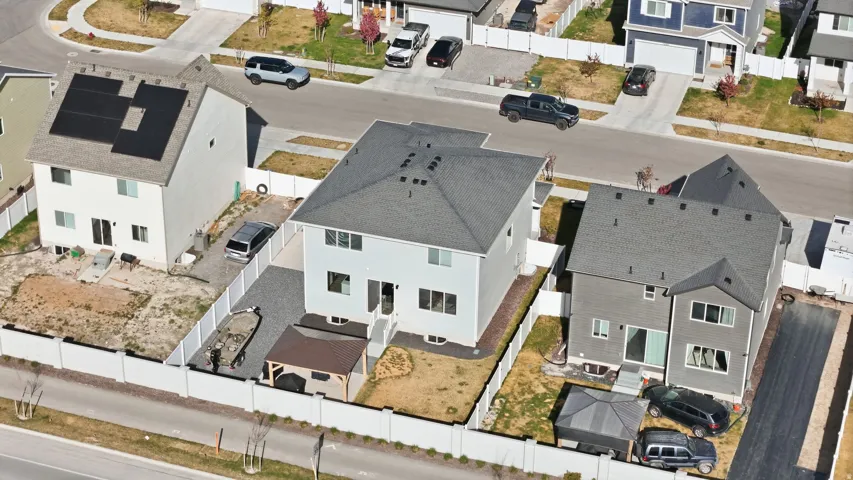 Contemporary two-story residence featuring a gray exterior siding and a dark gray shingle roof