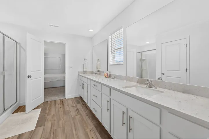 Dual vanity with white cabinetry, light-toned countertops, and two undermount sinks