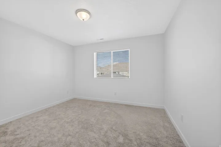 Neutral-toned carpet flooring and white painted walls