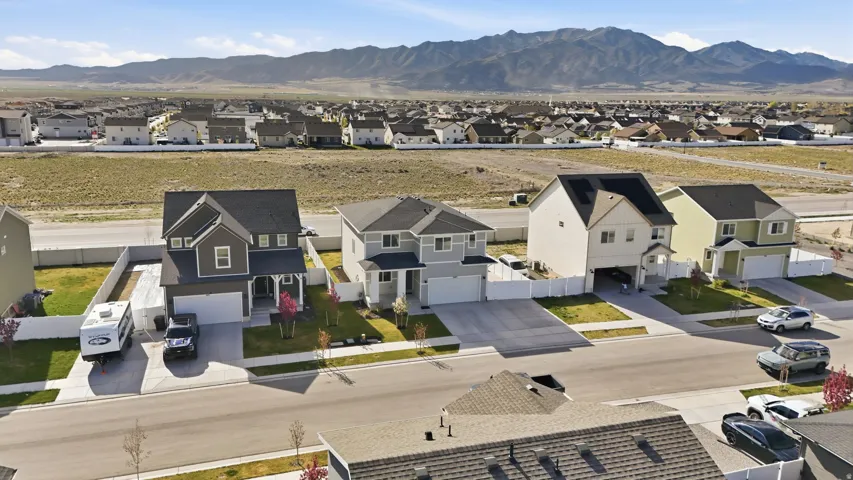 Modern residential street with homes featuring two-car garages and private driveways