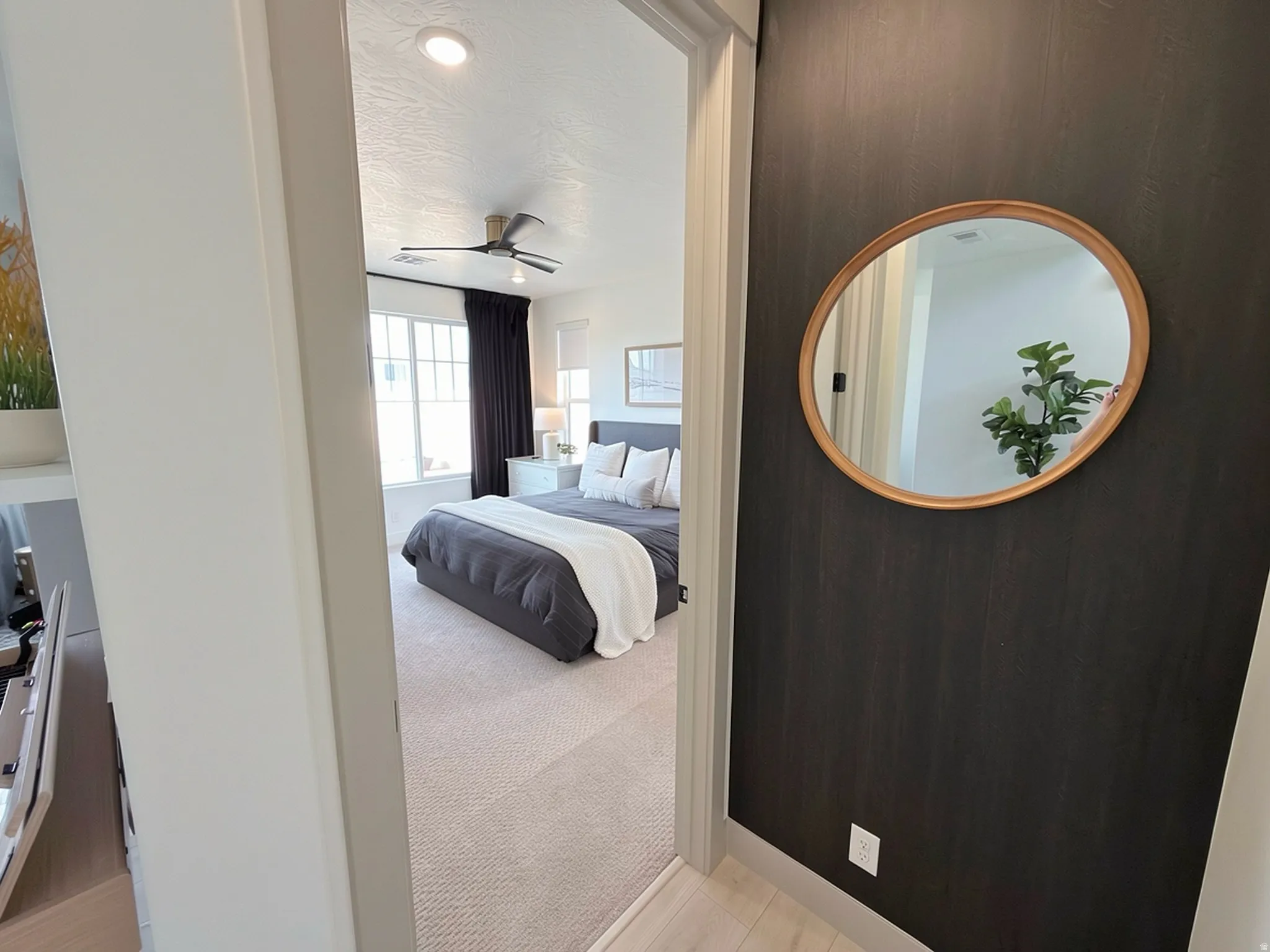 Bedroom featuring a ceiling fan with integrated lighting, recessed ceiling lighting, and multi-pane windows with dark drapes