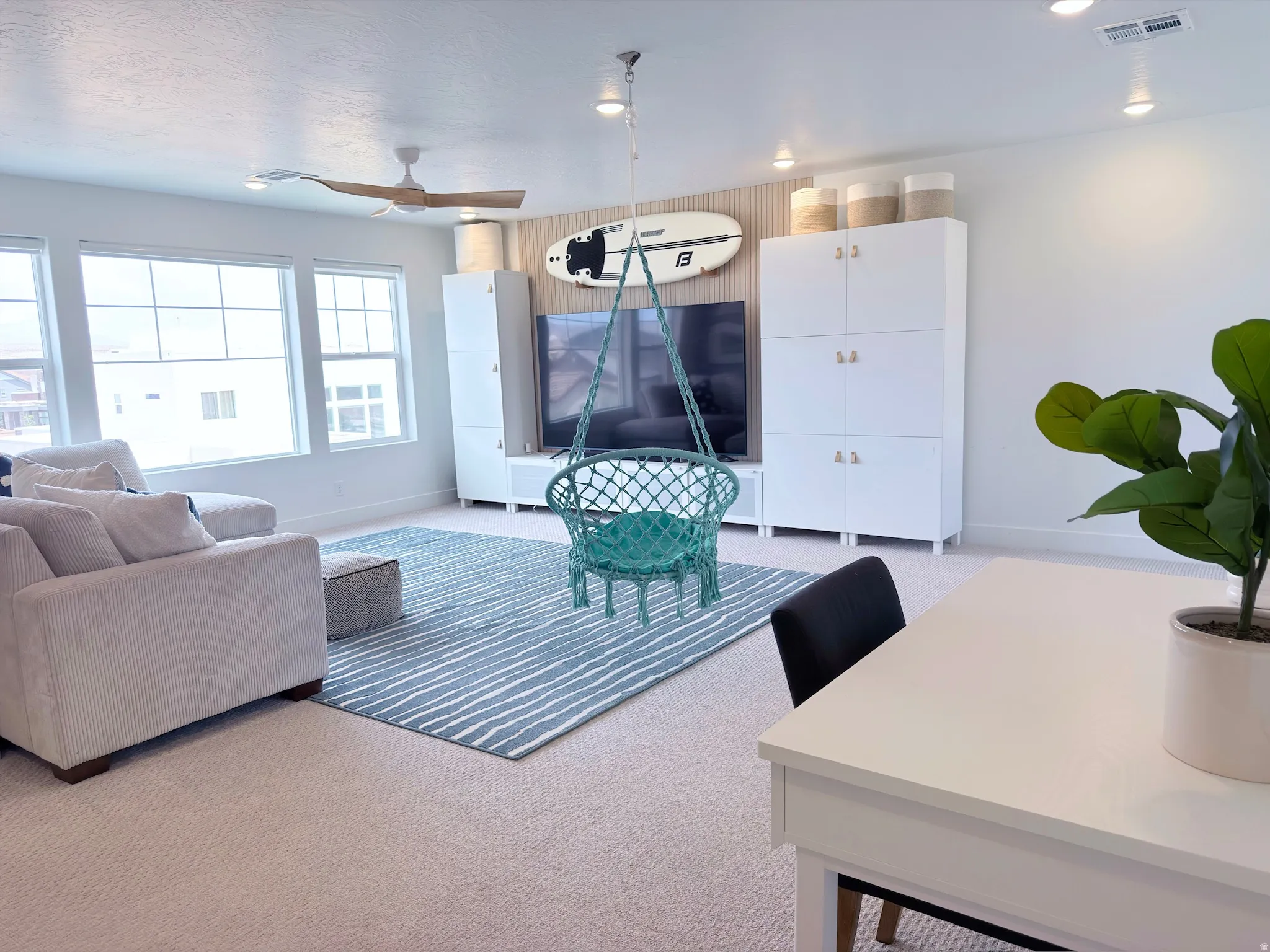 Spacious room featuring multiple windows, recessed lighting, and a ceiling fan