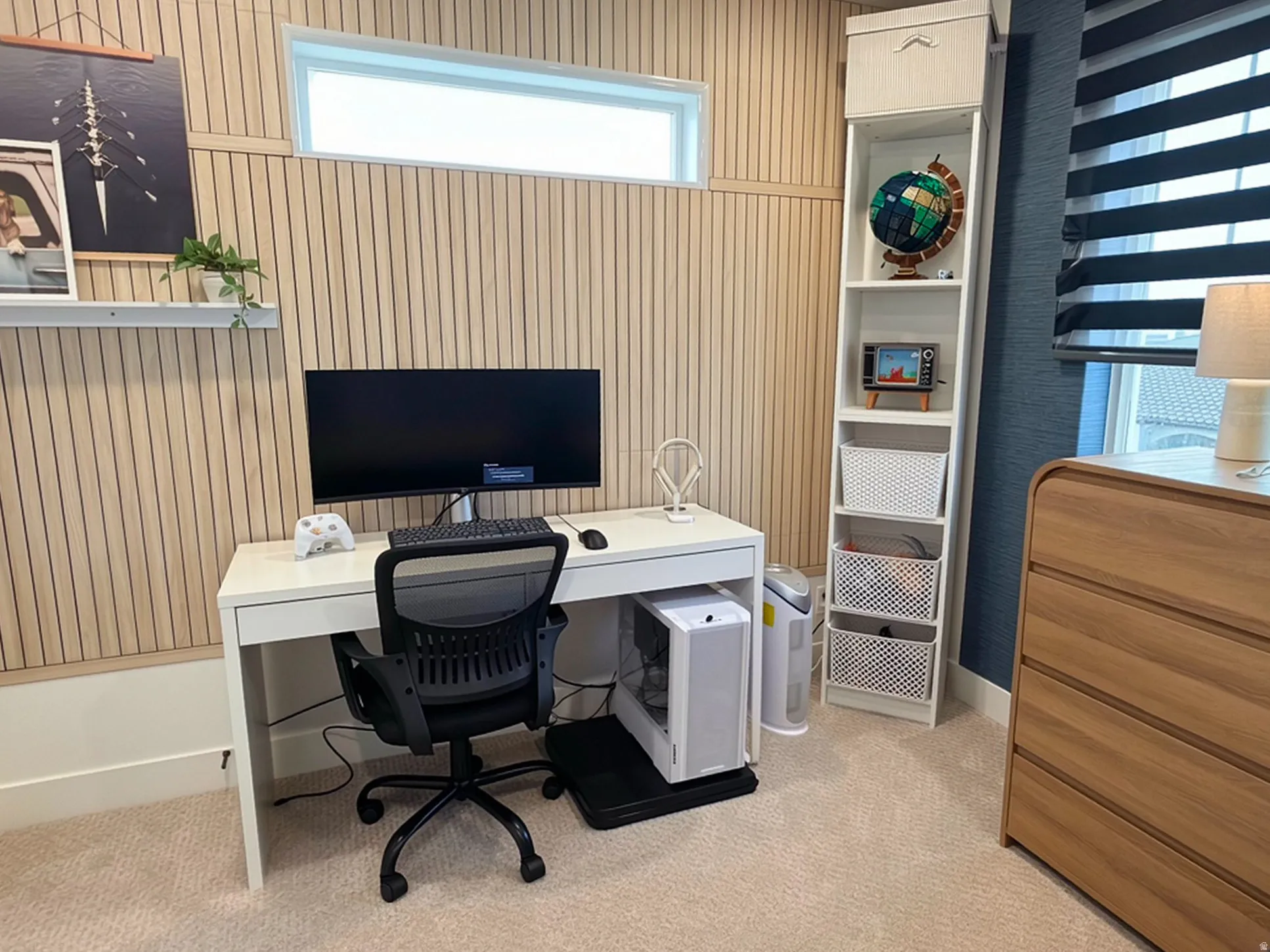 Dedicated workstation featuring slat-paneled walls and a transom window