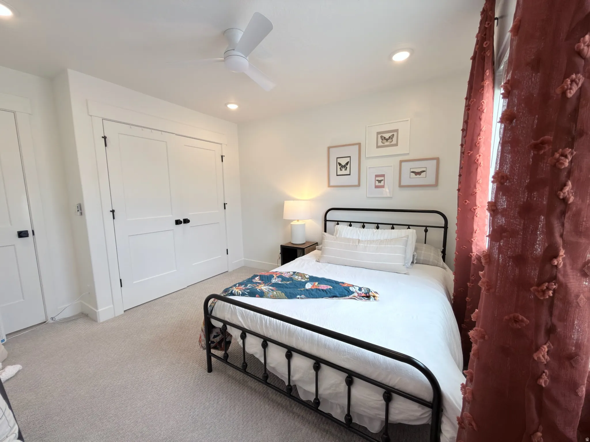 White walls and light-colored carpeting create a bright interior