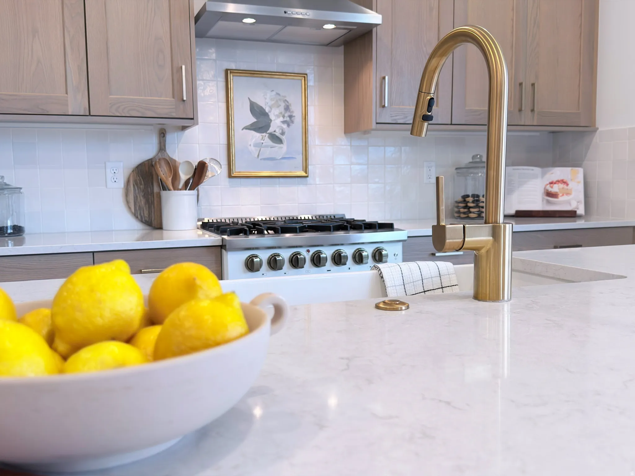 Kitchen featuring light wood-finish cabinetry, a white subway tile backsplash, and light-toned countertops