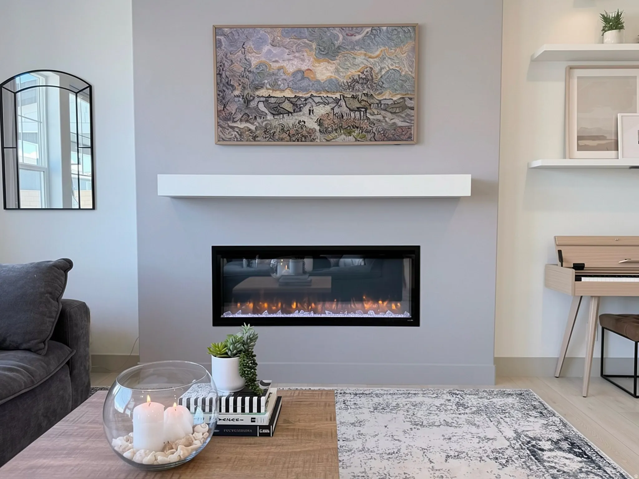 Modern electric fireplace with a sleek white mantel, set against a light gray accent wall